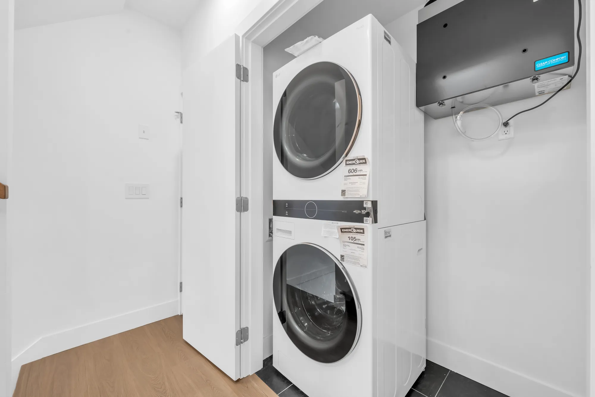 A stacked washer and dryer in a closet off the hall